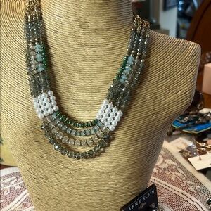 N Y necklace in fashion beads on golden chain.